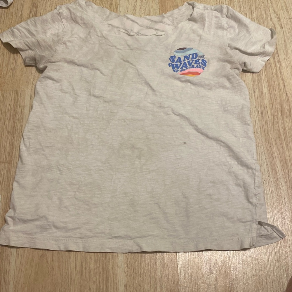 Wight shirt with blue words from pink and is a size small in women's
